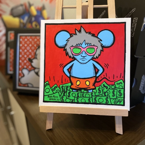 Andy Mouse in blue, grey hair, orange shorts, wearing sunglasses and standing in a pile of money